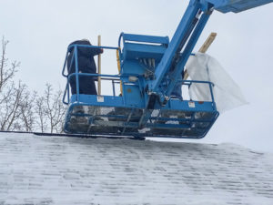Working Hand crew at work for a residential roof repair during winter