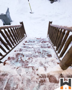 Shoveling a driveway and a deck by Working Hands LLC, a general contractor in Wasilla Alaska