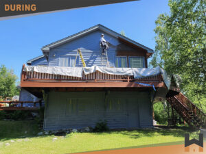 Home painting in progress with crew applying new color to siding