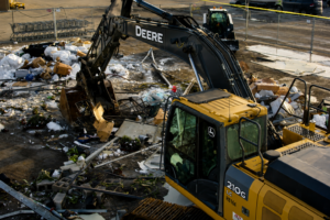 Excavator clearing debris during Lowe’s Garden Center demolition in Wasilla, Alaska