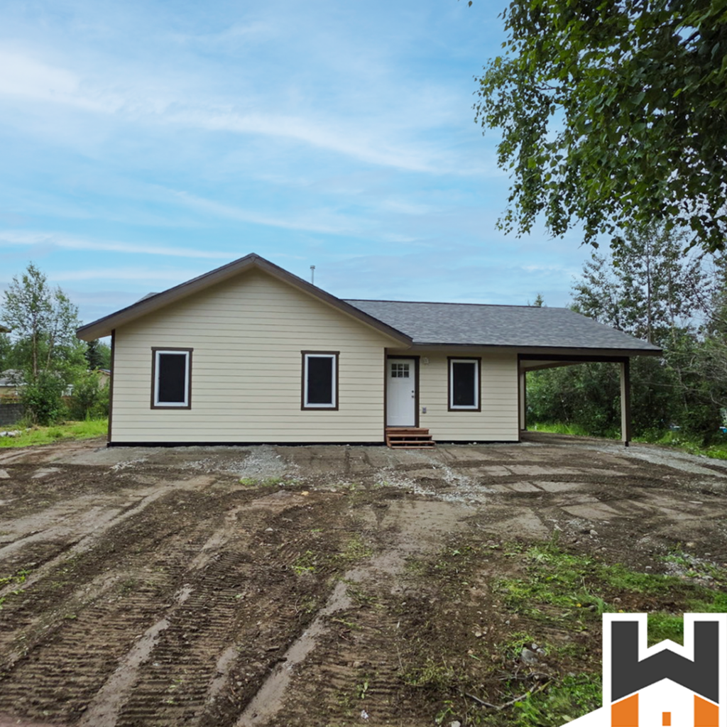 Completed Wasilla home rebuild exterior with covered carport